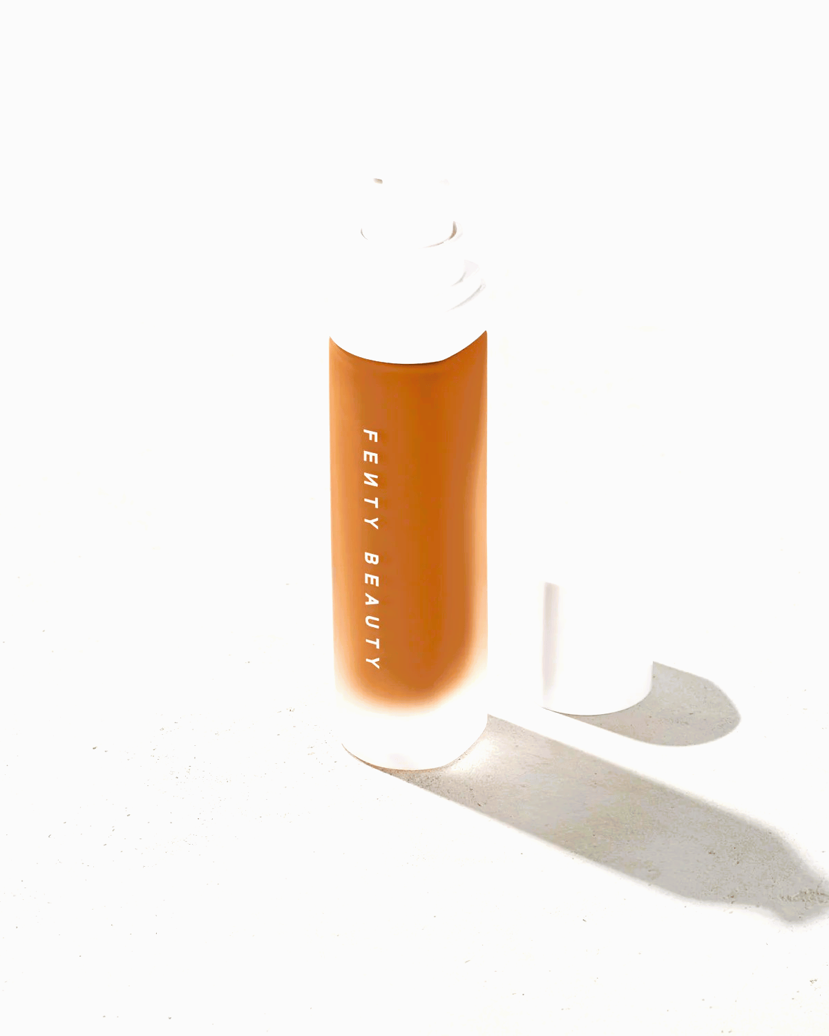 dnf0744s A sleek bottle of Pro Filt'r Soft Matte Longwear Foundation, featuring a luxurious frosted glass design with a minimalist pump dispenser. The rich, velvety formula is visible, promising a smooth, shine-free, long-lasting finish for all skin tones